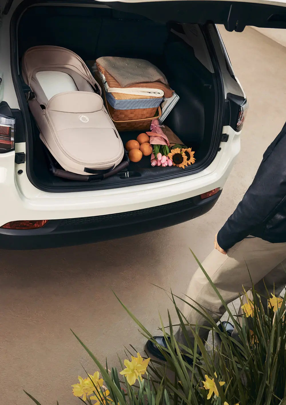 Der Kinderwagen ist mitsamt der Bugaboo Liegewanne für den Kinderwagen Dragonfly Plus flach zusammengeklappt und platzsparend im Kofferraum eines Autos verstaut.