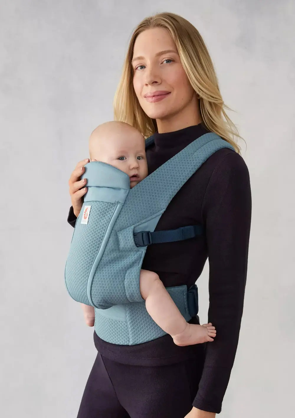 Frau trägt Baby in der Ergobaby Babytrage 'Omni Lite' Mesh Slate Blue