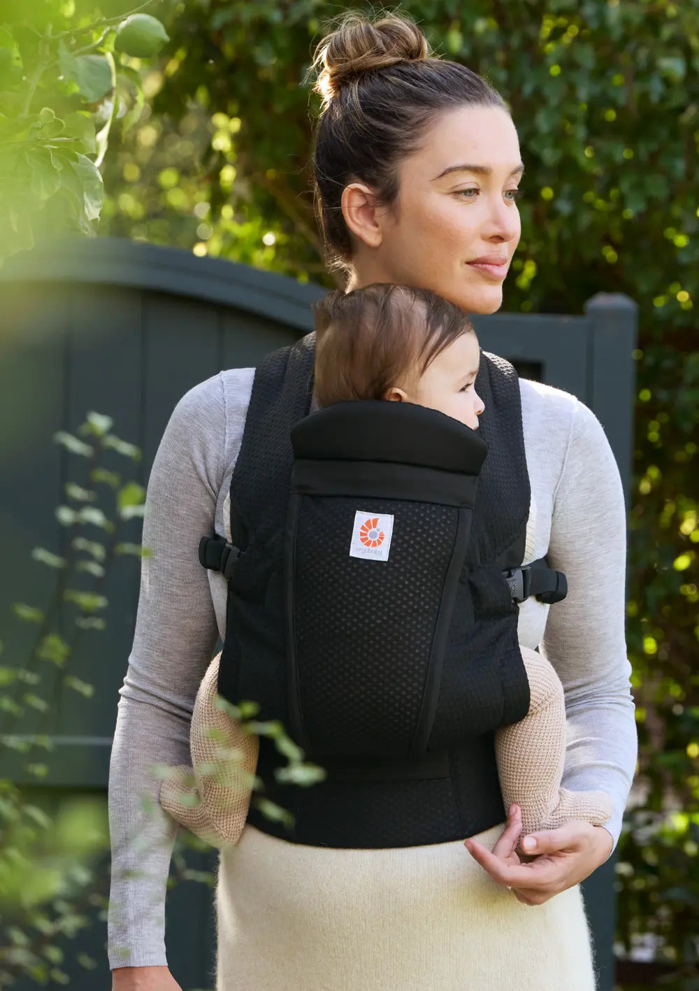 Frau trägt Baby in der Ergobaby Babytrage 'Omni Lite' Mesh Onyx Black